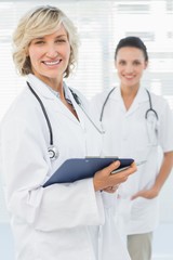 Fototapeta premium Portrait of a beautiful female doctor with clipboard