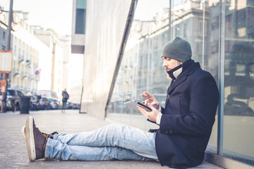 multitasking man using tablet, laptop and cellhpone
