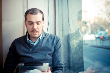 multitasking man using tablet, laptop and cellhpone