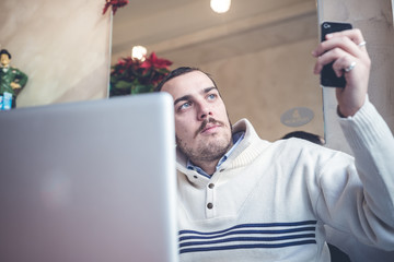 multitasking man using tablet, laptop and cellhpone