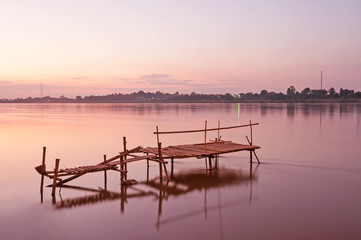 Fototapeta premium Tranquil sunset with a jetty on Mekong river in autumn.