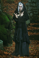 Dark witch posing in the woods