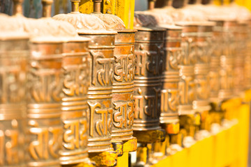 Spinning Tibetan Buddhist prayer wheels at Boudhanath stupa
