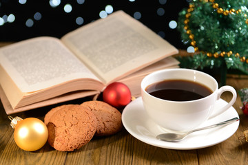 Composition of book with cup of coffee and Christmas