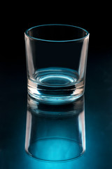empty glass on black background illuminated