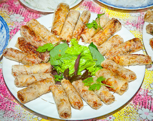 Vietnamese rice vegetable spring roll served on plate .