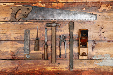 old vintage hand tools on wooden background