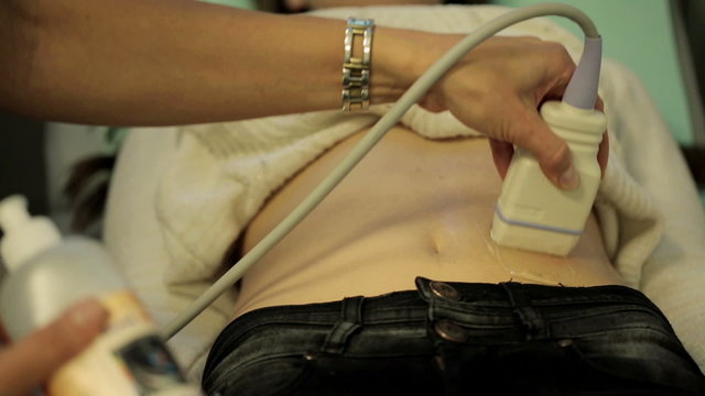 Ultrasound belly scanning of the young woman