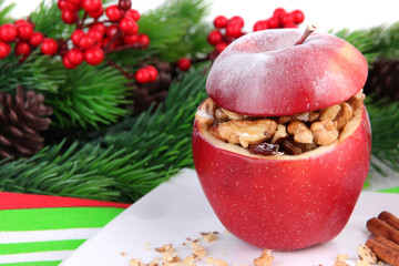 Stuffed Christmas apple with nuts and raisins on table close up