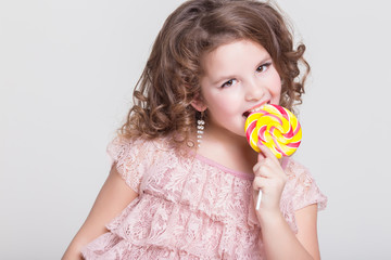 Little child with candy lollipop Funny baby girl