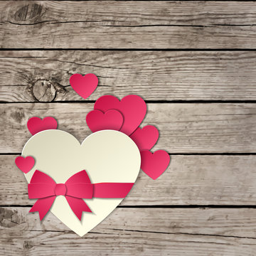 Heart with a bow on a wooden background vector