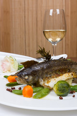 Grilled trout served with risotto and Brussels sprouts