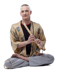 Yoga guru playing flute, isolated on white © Wisky