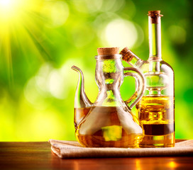 Olive Oil on the Table over Green Nature Background
