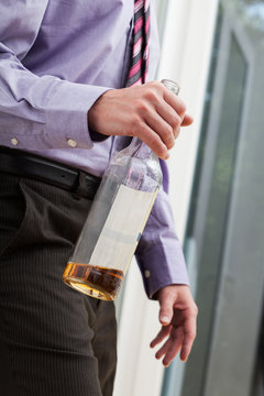 Drunk businessman holding a bottle