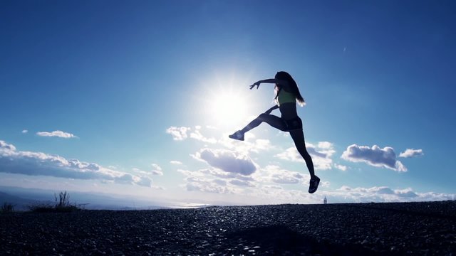 Woman Jumping At Sunset