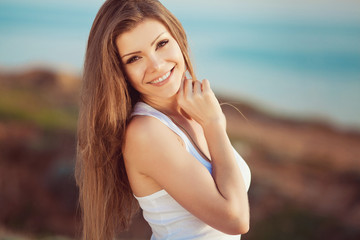 portrait of a woman on a background of mountains and sea