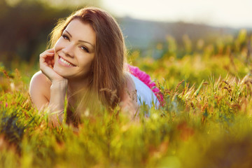 portrait  young woman on the meadow on a warm summer day
