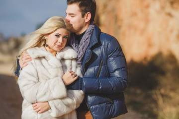 portrait of a young couple on a background of mountains