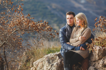 portrait of a young couple on a background of mountains