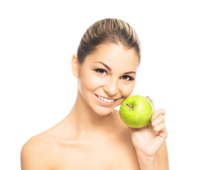 Portrait of a beautiful and happy woman holding a fresh apple