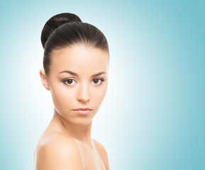 Portrait of a beautiful woman in spa style on a blue background