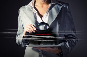 business woman holding a magnifying glass