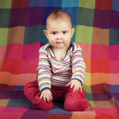 Cute serious boy portrait on colorful background