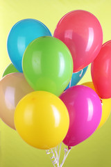 Fototapeta na wymiar Colorful balloons on green background