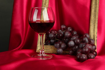 composition of frame,wine and grapes on bright background