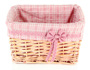 Wicket basket with pink fabric and bow, isolated on white