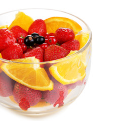 Useful fruit salad in glass cup isolated on white