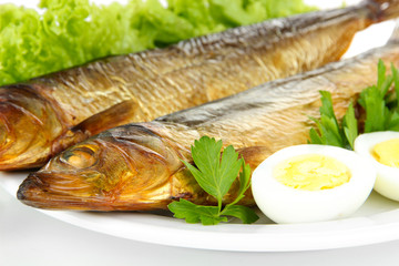 Smoked fish on plate close up