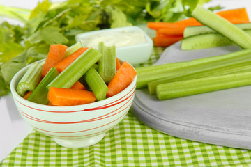 Fresh green celery with vegetables on table close-up