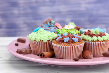 Tasty cupcakes with butter cream,