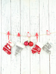 Christmas accessories hanging on white wooden wall