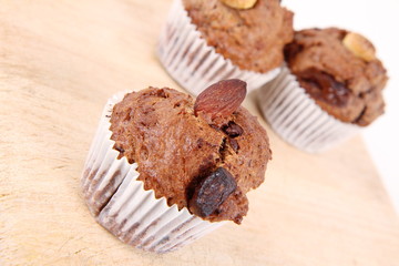 Chocolate muffins on a wooden background
