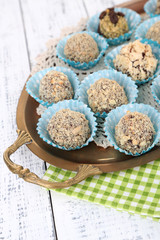 Set of chocolate candies, on tray, on color wooden background