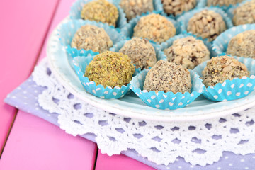 Set of chocolate candies, on wooden background