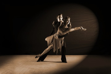 Latino dancers in ballroom isolated on black background