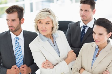 Confident and serious business team in office