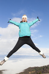 Young women joyfully jumping outdoors