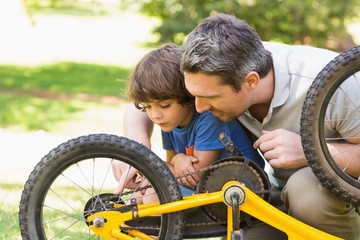 Father and son fixing bike