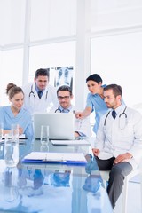 Concentrated medical team using laptop together