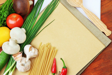 Cooking concept. Groceries with empty cookbook close up