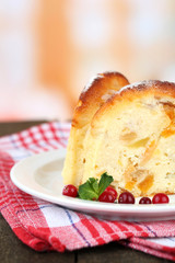 Slice of tasty homemade cake with berries, on wooden table