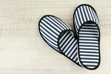 Striped slippers on wooden background