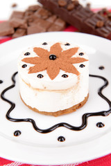 Sweet cake with chocolate on plate on table close-up