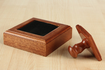 Wooden stamp on wooden background