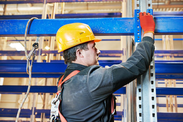 warehouse worker installing rack arrangement